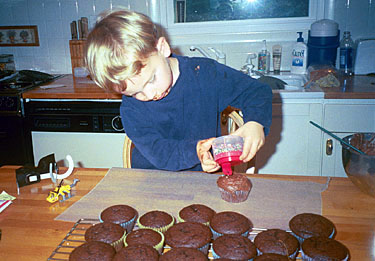 Evan decorating cup cakes, Fall 2002