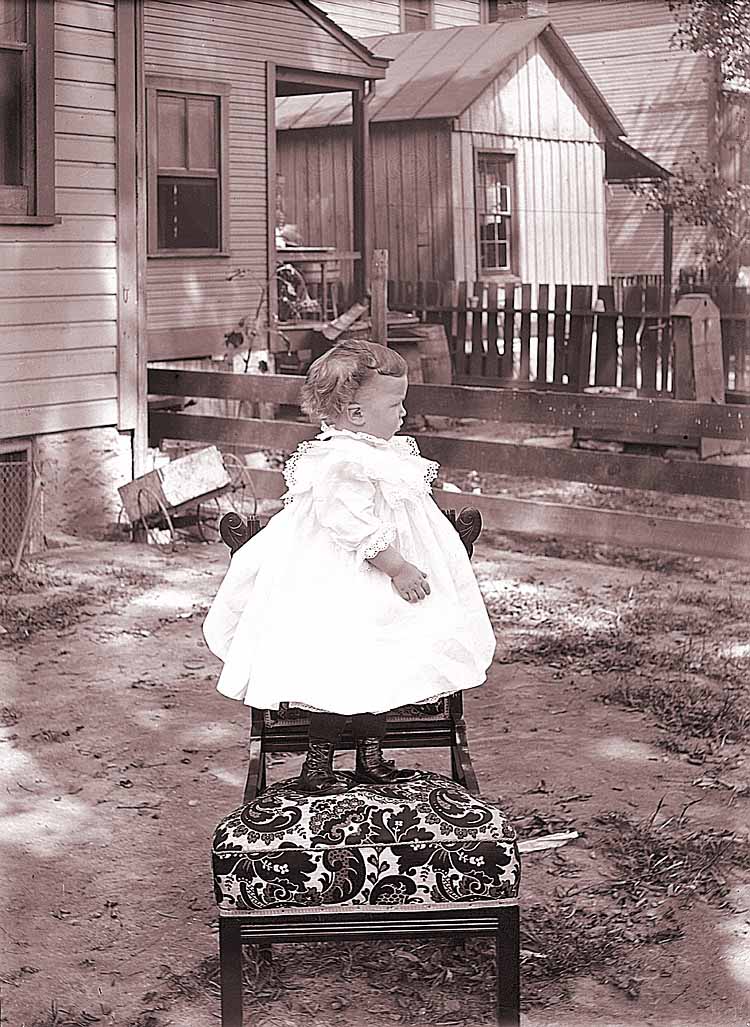 James Lee Fisher in a Dress standing on a chair, ca. 1897