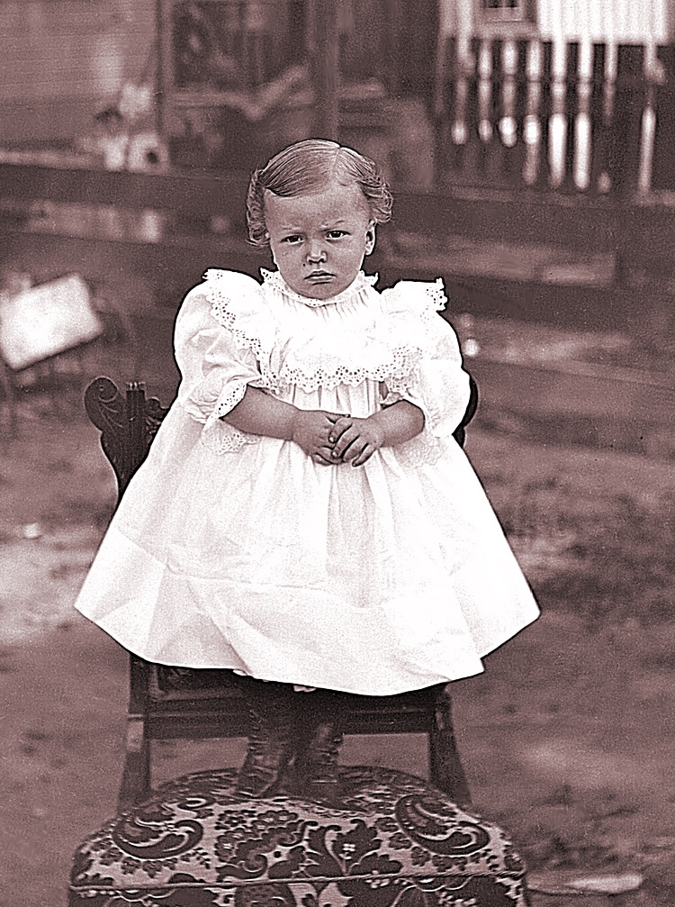 James Lee Fisher in a Dress standing on a chair, ca. 1897