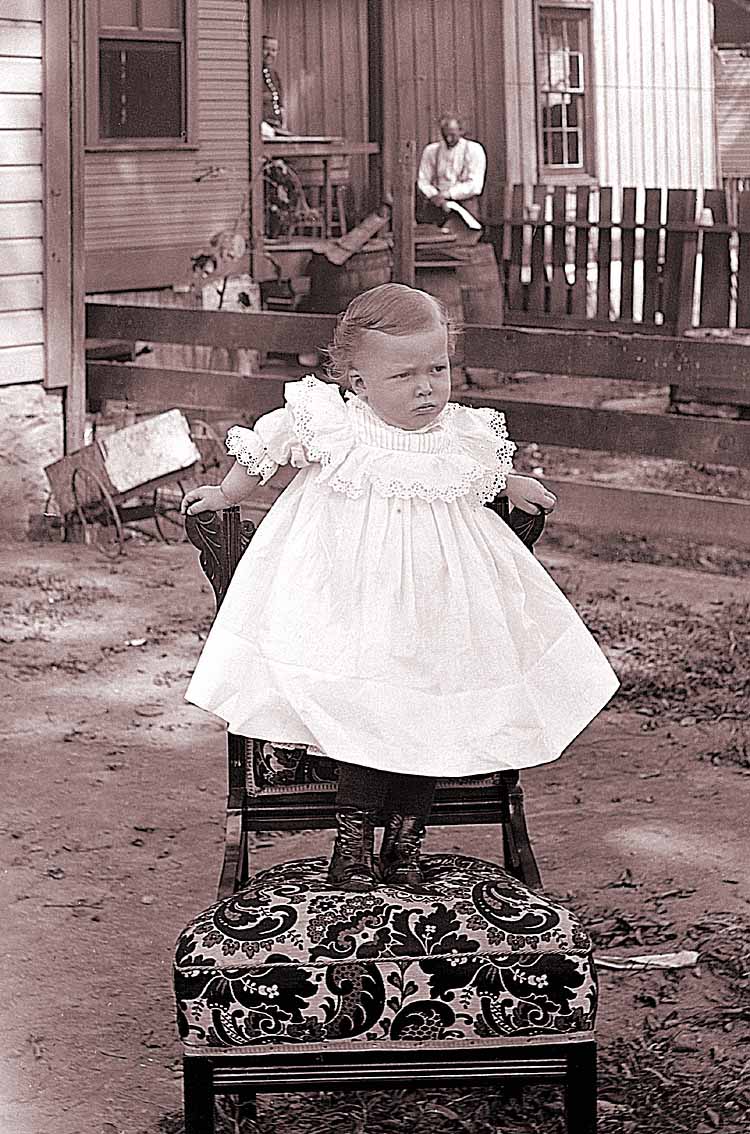 James Lee Fisher in a Dress standing on a chair, ca. 1897