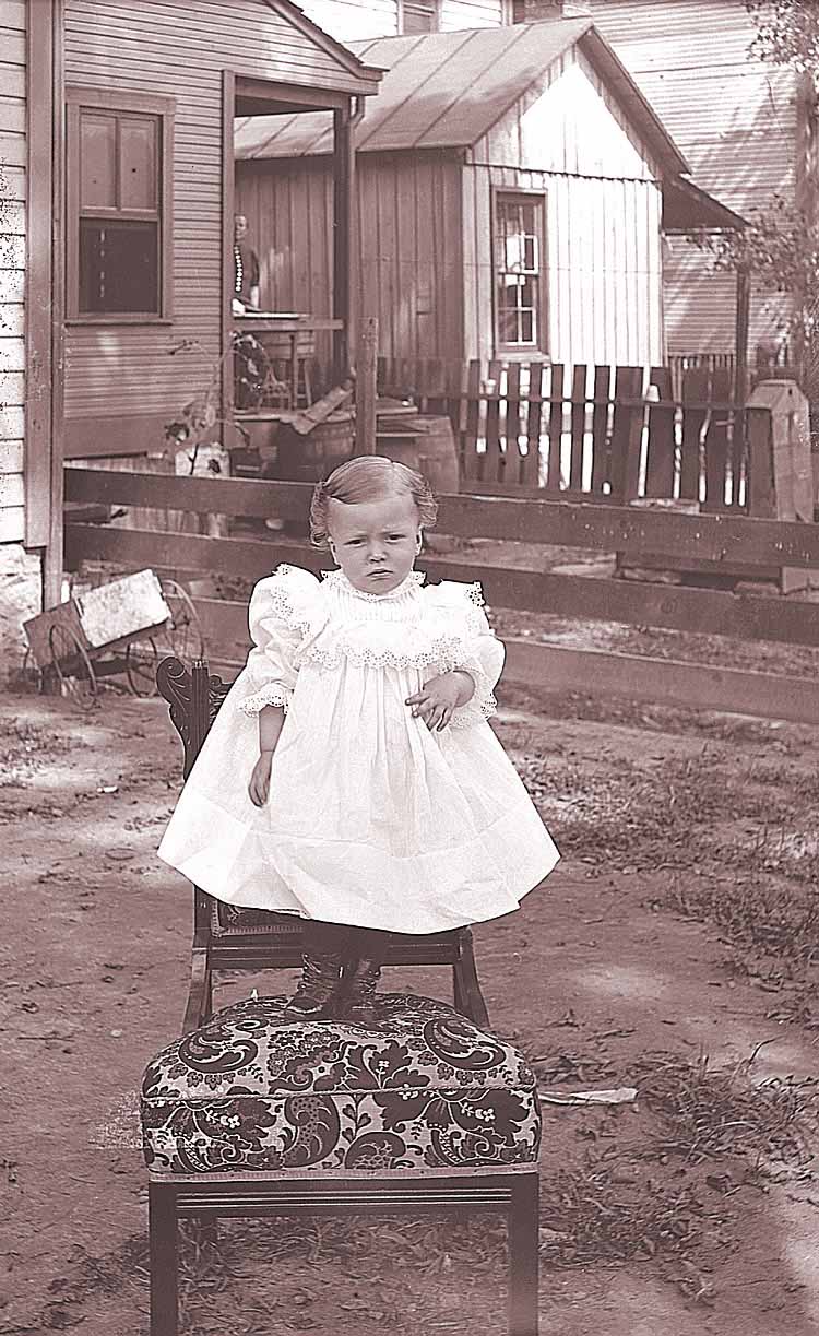 James Lee Fisher in a Dress standing on a chair, ca. 1897